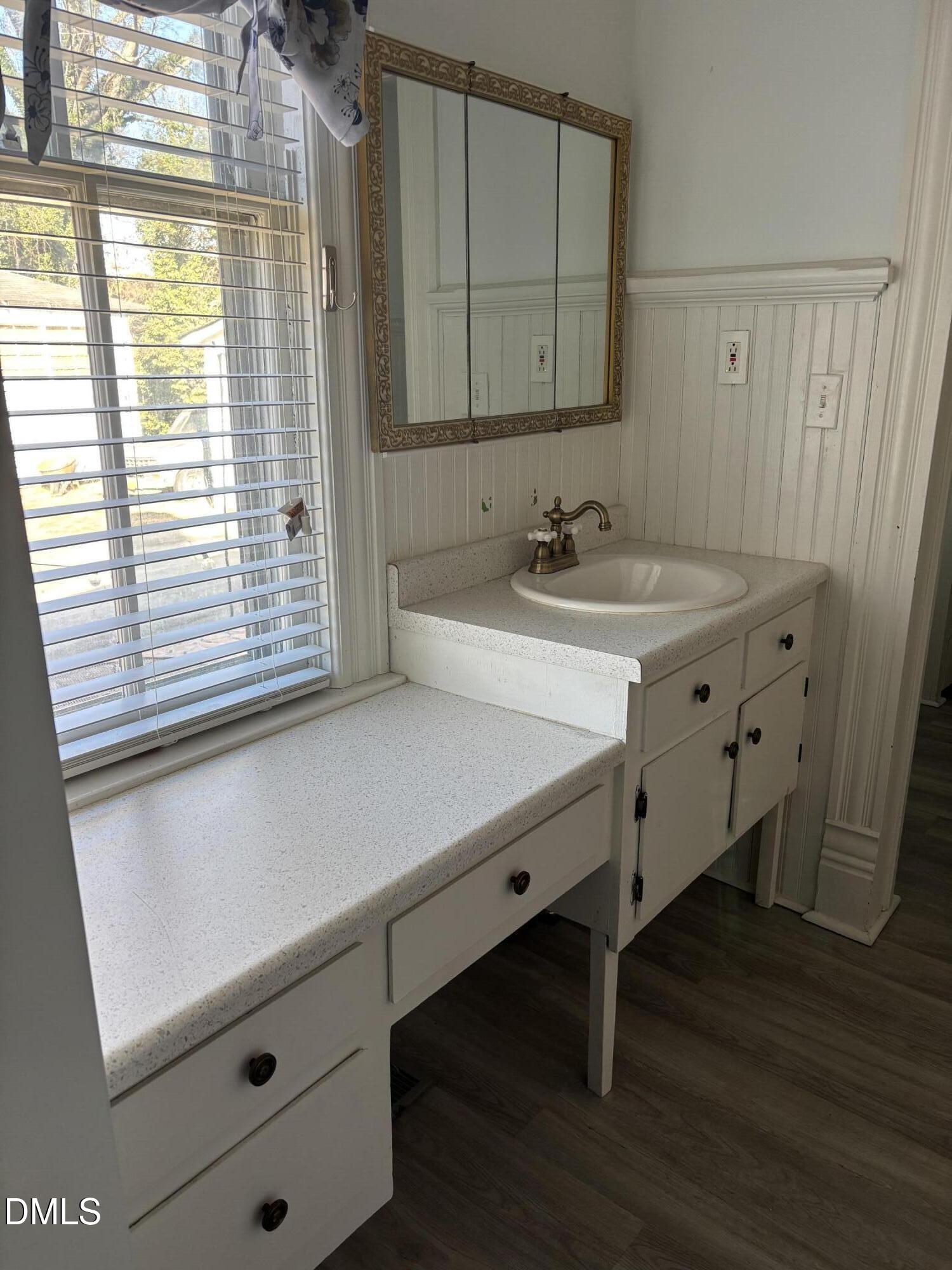 401 North Main Street Louisburg, NC 27549 - Photo 45 of 47 a bathroom with a sink and a mirror