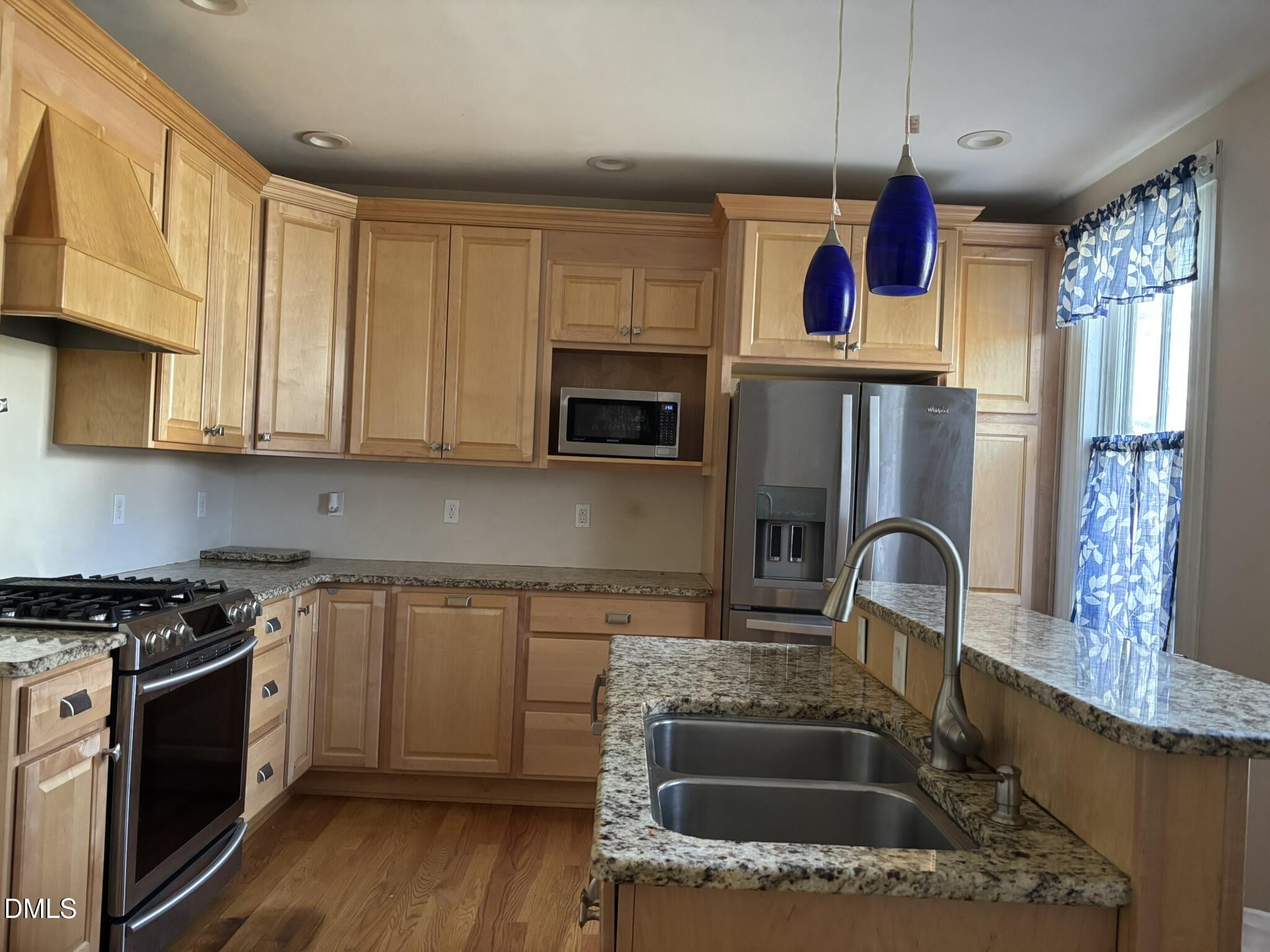 401 North Main Street Louisburg, NC 27549 - Photo 9 of 47 a kitchen with granite countertop a sink stainless steel appliances and cabinets