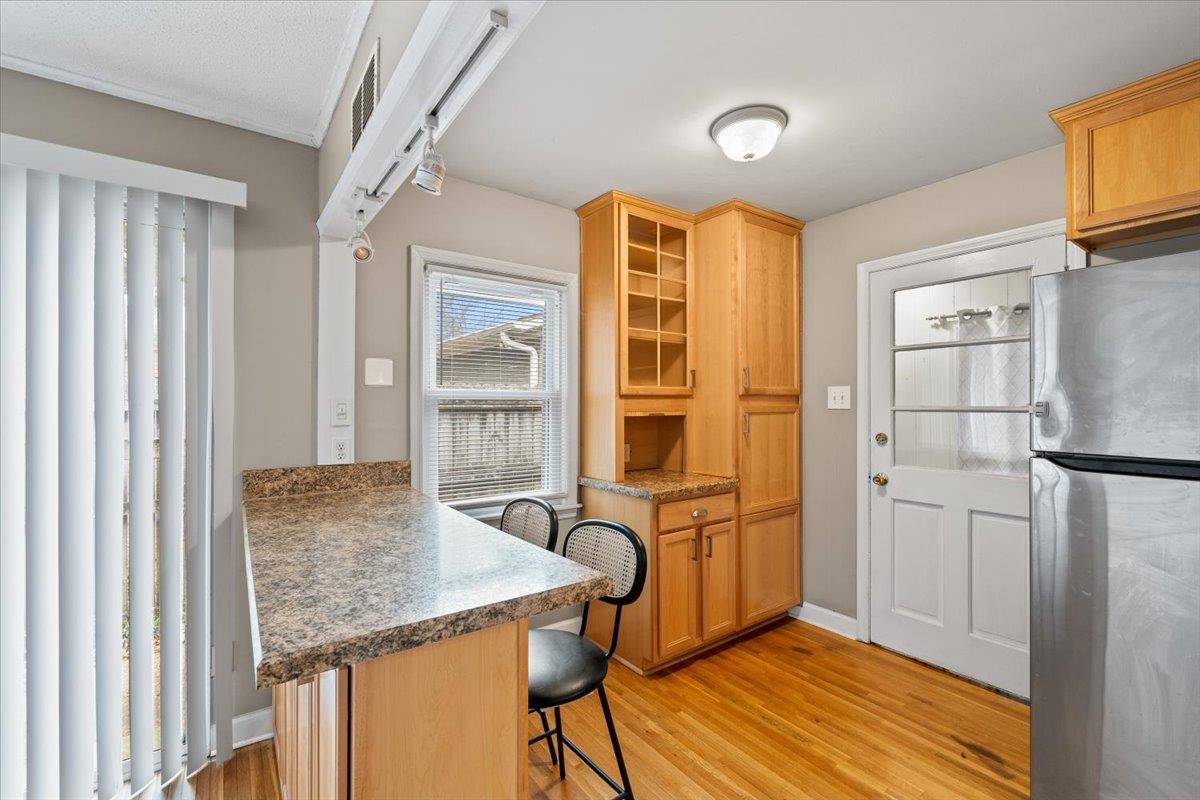 1073 Ivy Road Memphis, TN 38117 - Photo 11 of 33 a view of a kitchen with furniture and wooden floor