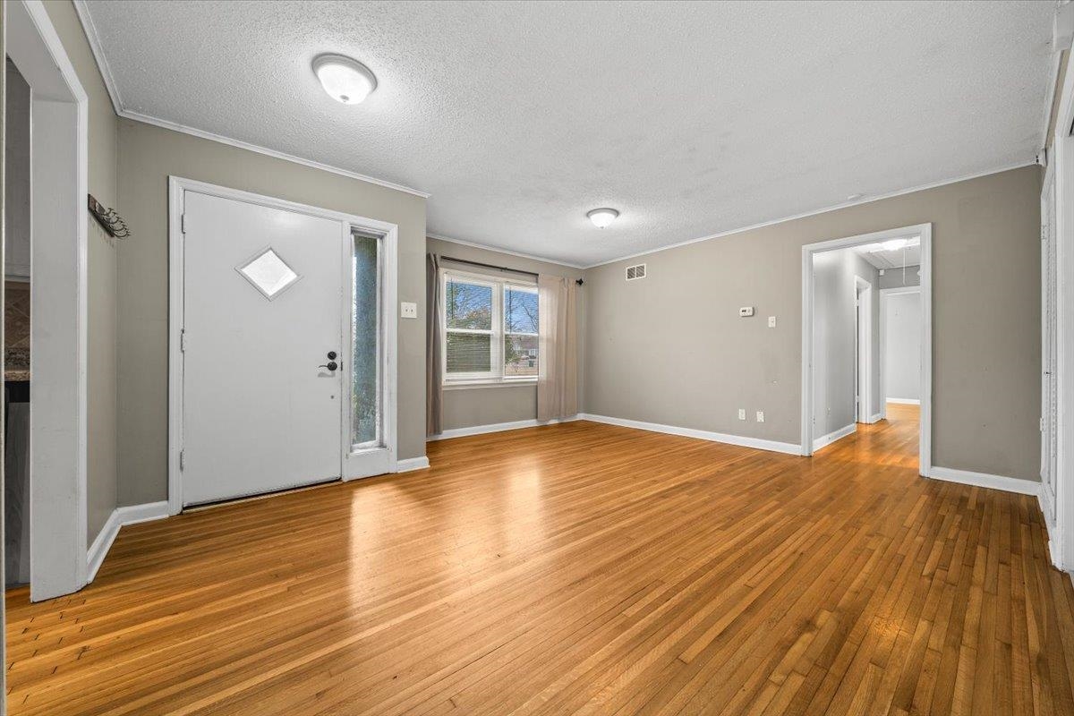 1073 Ivy Road Memphis, TN 38117 - Photo 15 of 33 wooden floor in an empty room with a window