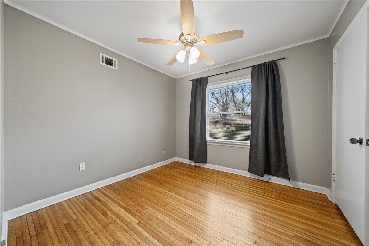 1073 Ivy Road Memphis, TN 38117 - Photo 18 of 33 a view of a livingroom with wooden floor and a ceiling fan