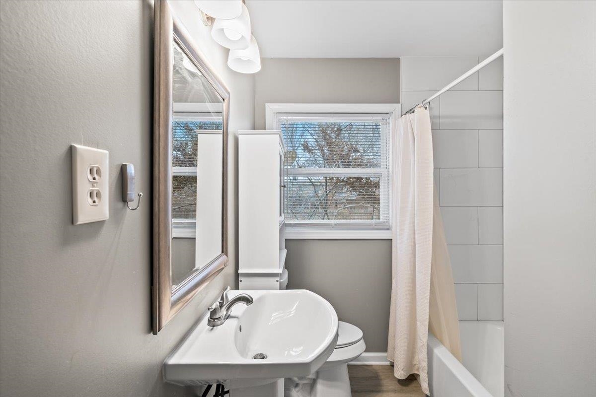 1073 Ivy Road Memphis, TN 38117 - Photo 19 of 33 a bathroom with a sink a mirror and a window