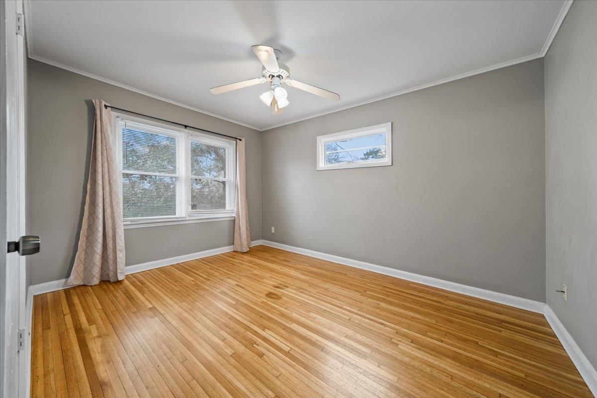 1073 Ivy Road Memphis, TN 38117 - Photo 20 of 33 a view of empty room with wooden floor and fan