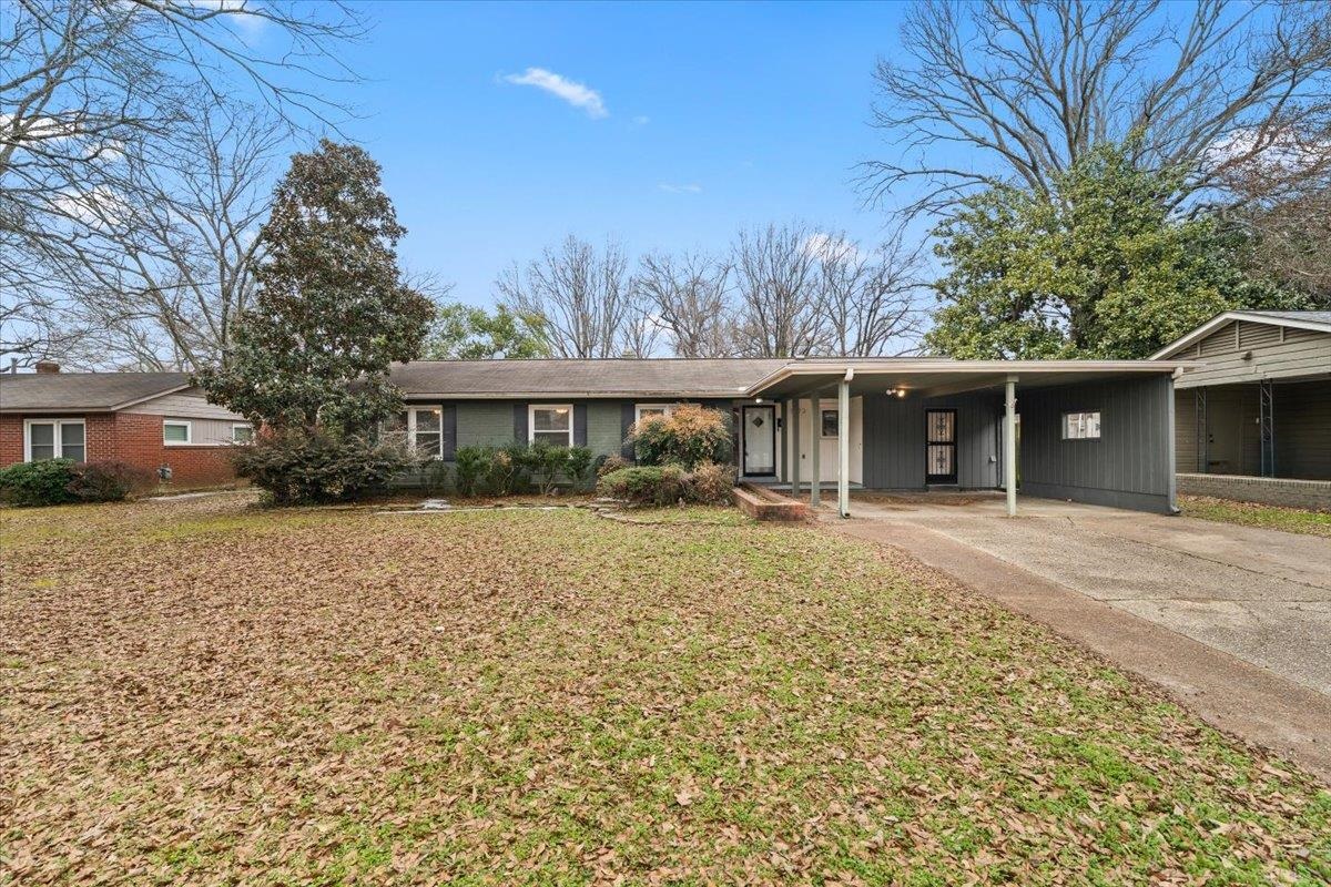 1073 Ivy Road Memphis, TN 38117 - Photo 27 of 33 a front view of a house with a yard and potted plants