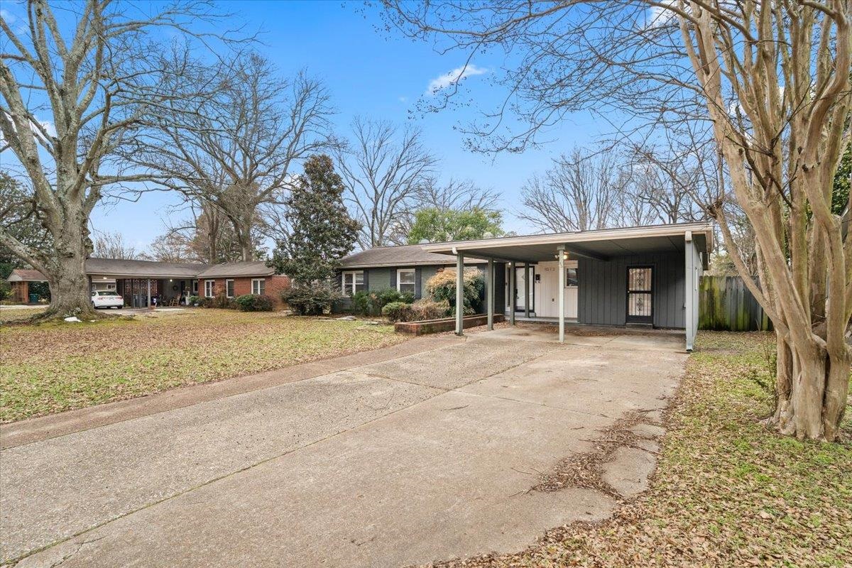 1073 Ivy Road Memphis, TN 38117 - Photo 28 of 33 a front view of a house with a yard and garage