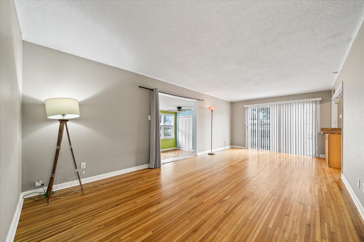 1073 Ivy Road Memphis, TN 38117 - Photo 6 of 33 a view of an empty room with a window and wooden floor