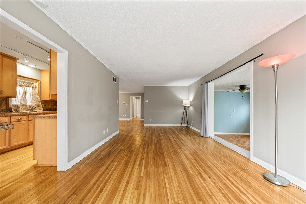 1073 Ivy Road Memphis, TN 38117 - Photo 7 of 33 a view of a big room with wooden floor and natural light