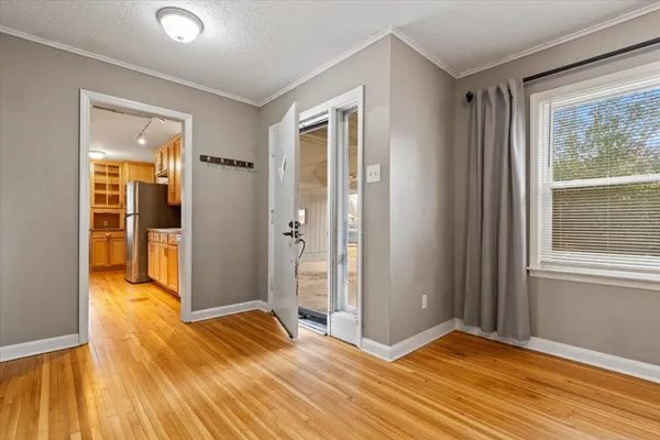 a view of a kitchen with furniture and wooden floor