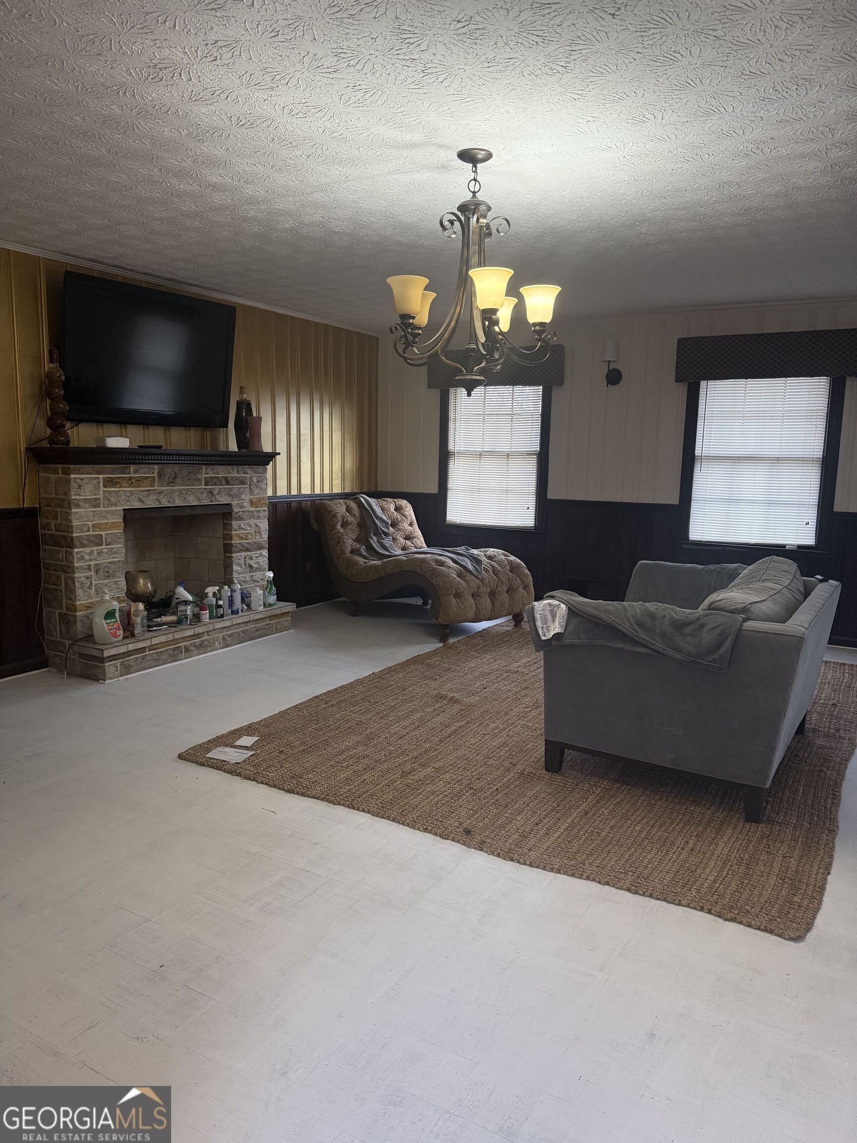 3861 Newnan Road Griffin, GA 30223 - Photo 27 of 89 a living room with furniture a fireplace and a flat screen tv