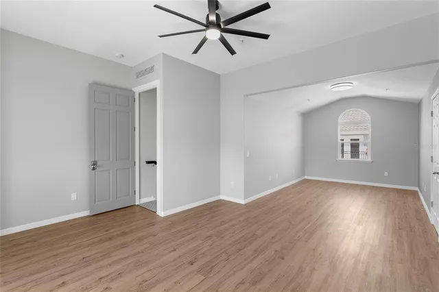 a view of a livingroom with wooden floor and a ceiling fan