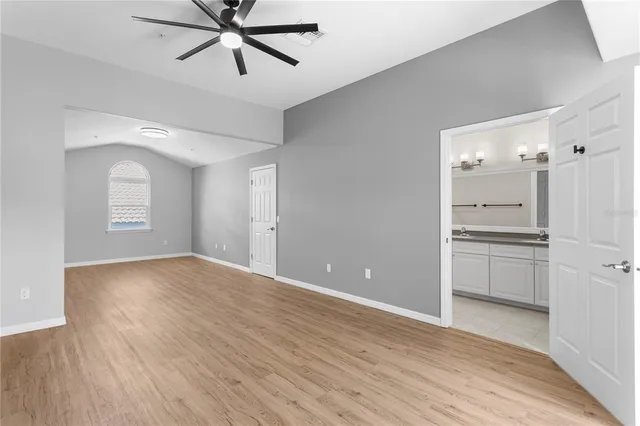 a view of a kitchen with a sink and a refrigerator