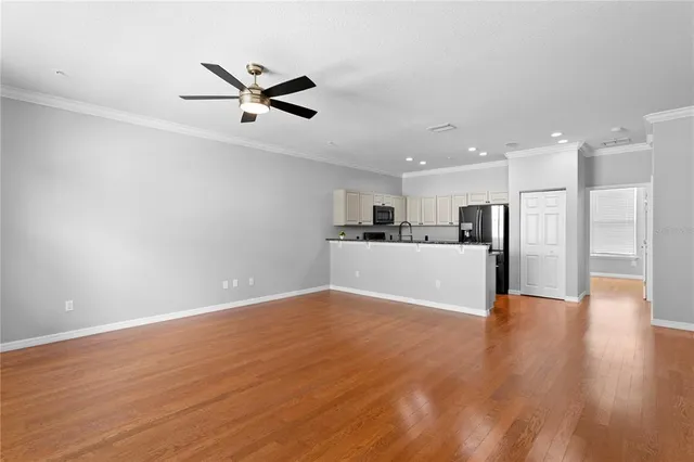 a view of a kitchen with a sink and wooden floor