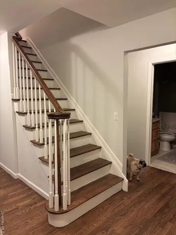 a view of entryway and hall with wooden floor