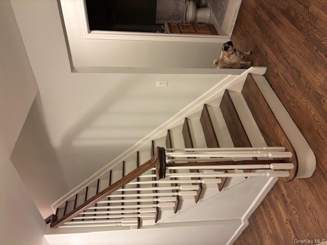 96 West Tiana Road Hampton Bays, NY 11946 - Photo 12 of 21 Stairs featuring wood finished floors and baseboards