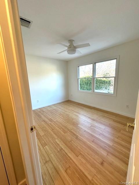 96 West Tiana Road Hampton Bays, NY 11946 - Photo 18 of 21 Bedroom with bamboo flooring & ceiling fan
