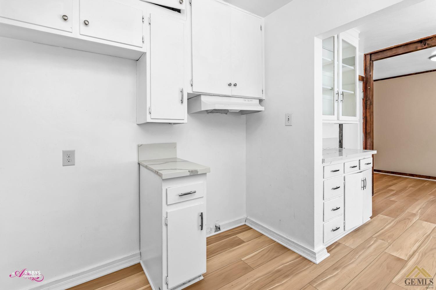Undisclosed Address Bakersfield, CA 93308 - Photo 14 of 37 a view of cabinets and wooden floor