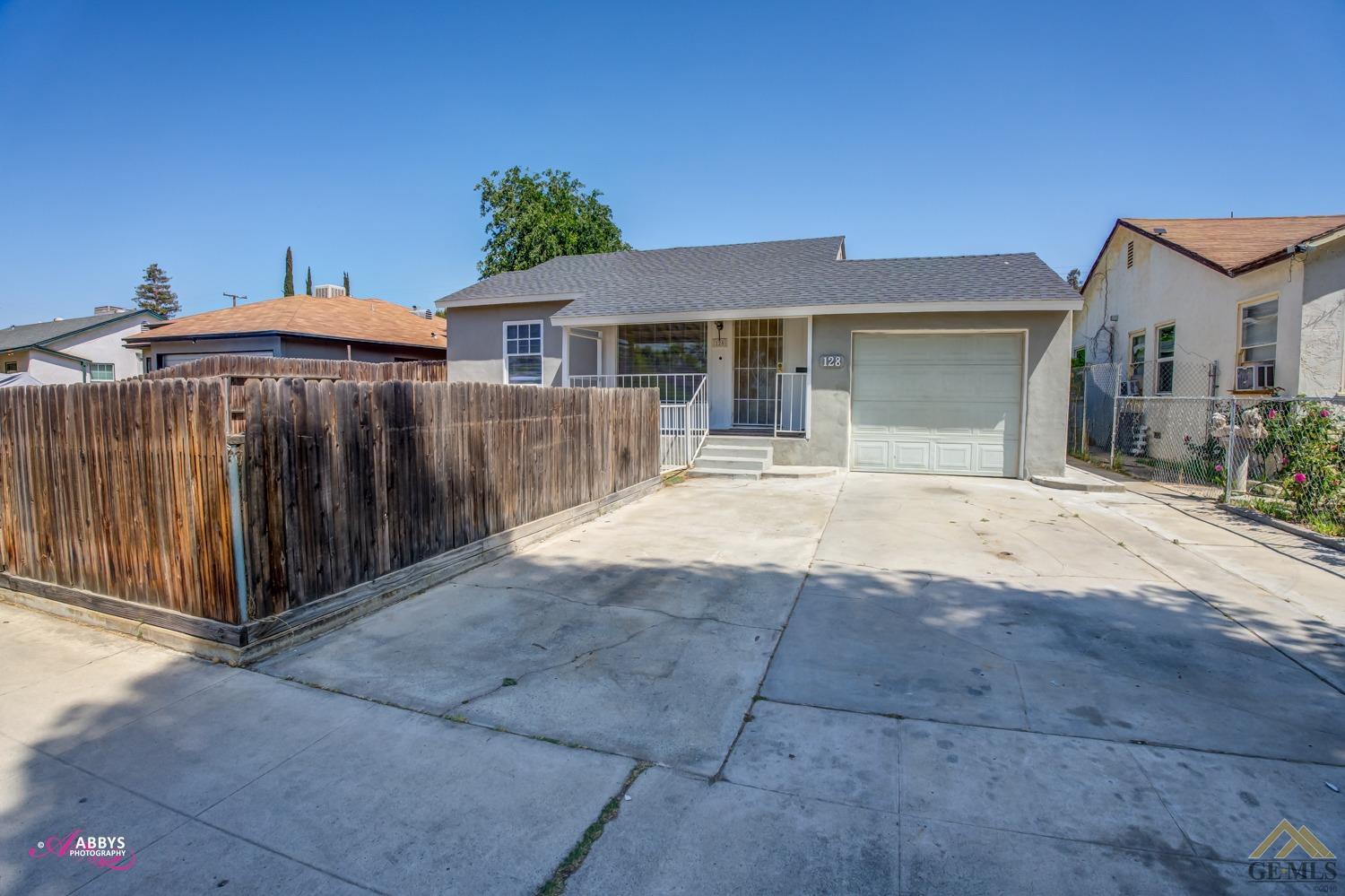 Undisclosed Address Bakersfield, CA 93308 - Photo 2 of 37 a front view of a house with a yard