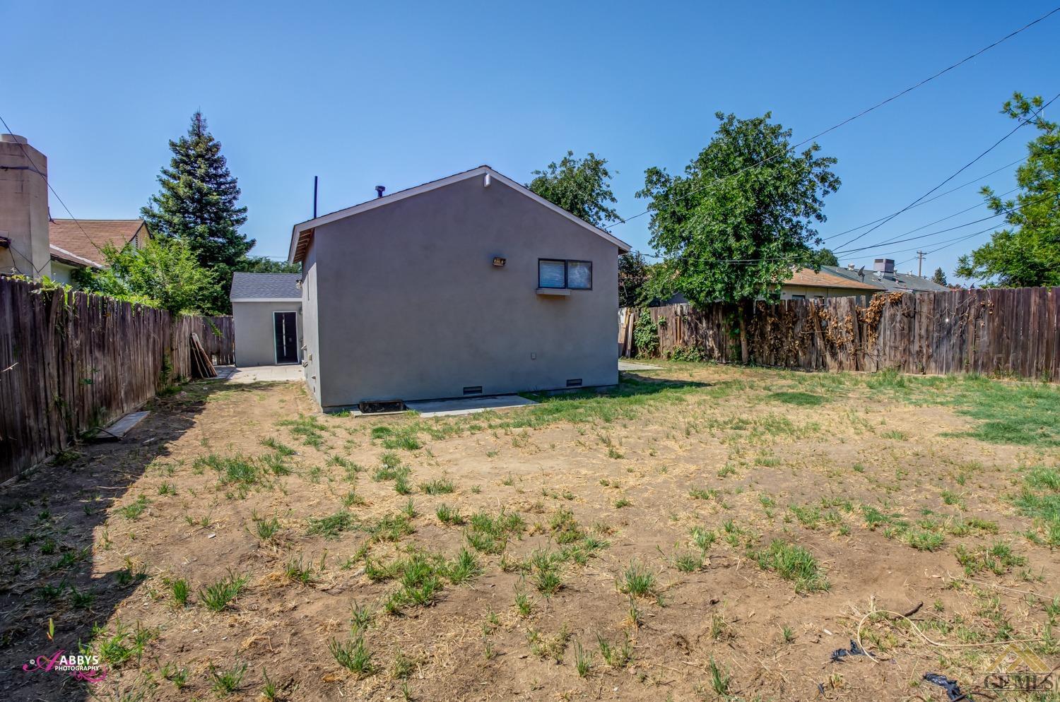 Undisclosed Address Bakersfield, CA 93308 - Photo 32 of 37 a backyard of a house with plants and wooden fence