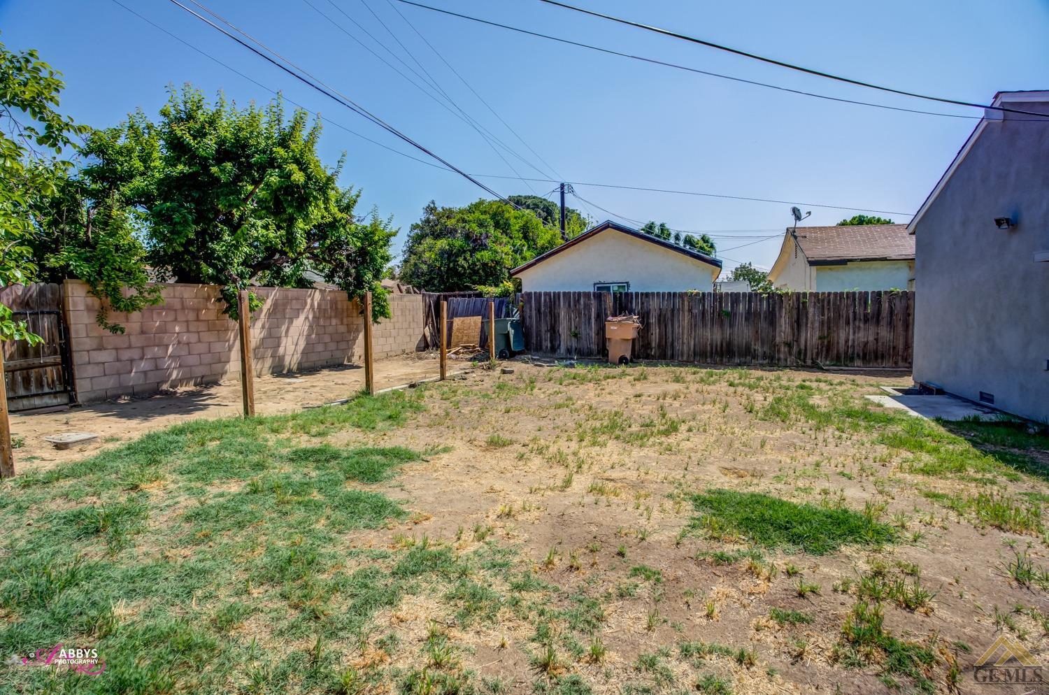 Undisclosed Address Bakersfield, CA 93308 - Photo 35 of 37 a blue swimming pool is sitting in front of a house