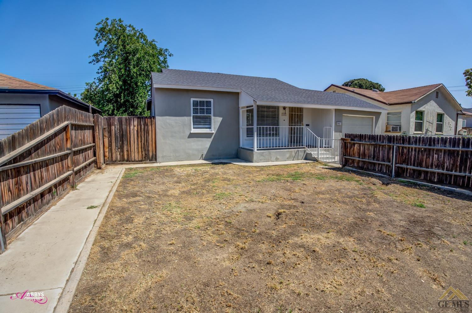 Undisclosed Address Bakersfield, CA 93308 - Photo 4 of 37 a front view of a house with a yard
