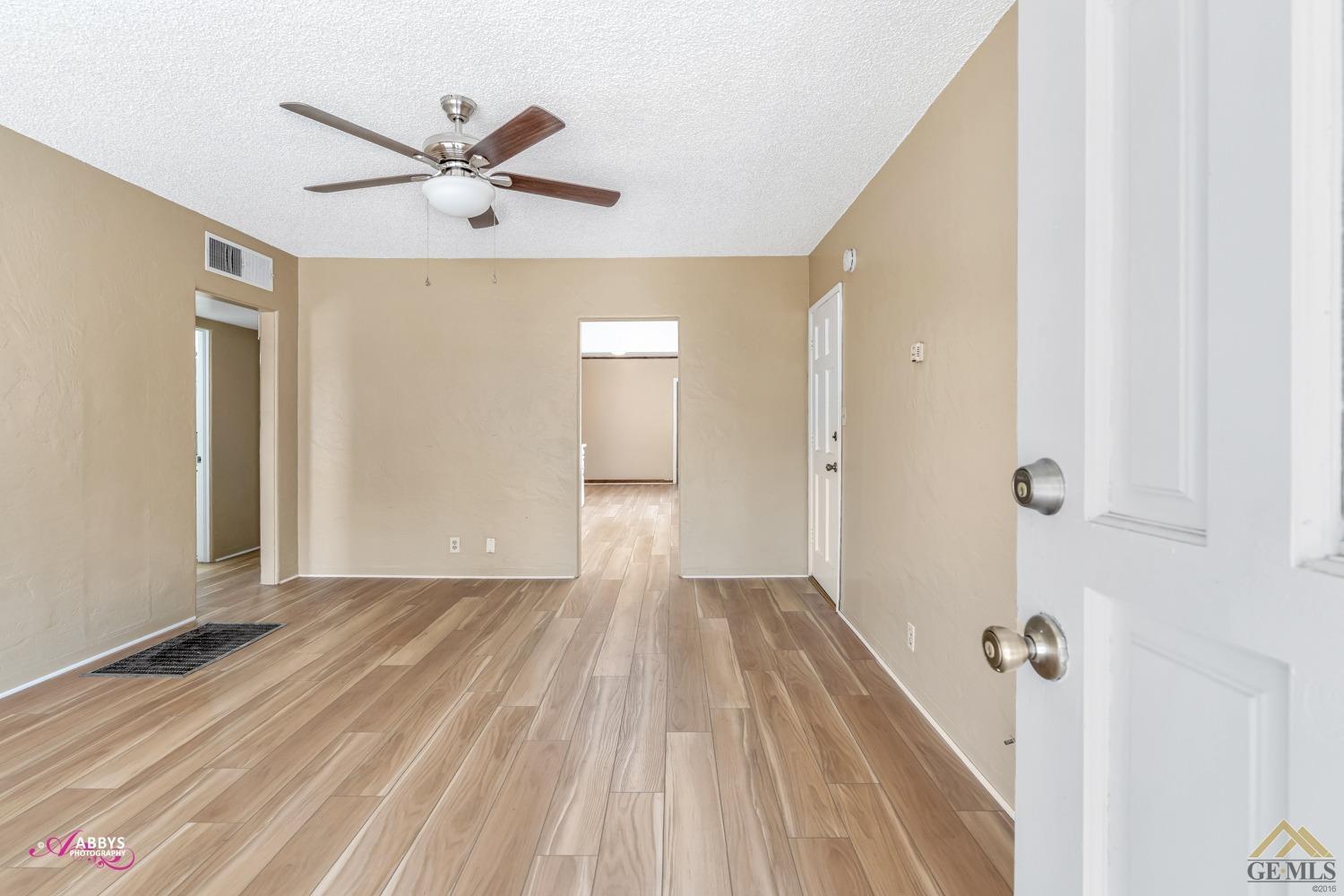 Undisclosed Address Bakersfield, CA 93308 - Photo 8 of 37 a view of a livingroom with a hardwood floor and a ceiling fan