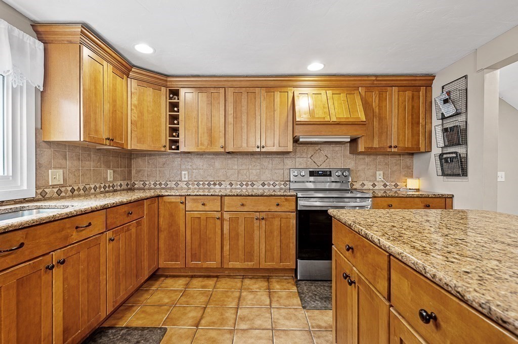 5 Torrey Road Sutton, MA 01590 - Photo 10 of 42 a kitchen with stainless steel appliances granite countertop a stove sink and cabinets