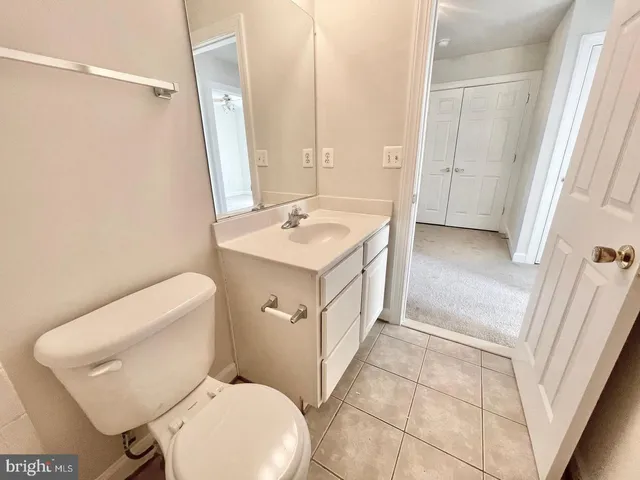 a white toilet sitting next to a bathroom sink