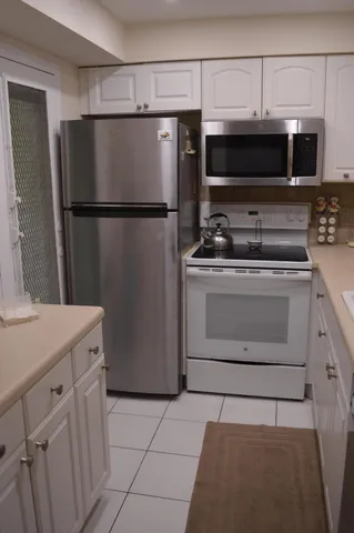 a kitchen with stainless steel appliances a refrigerator stove and microwave