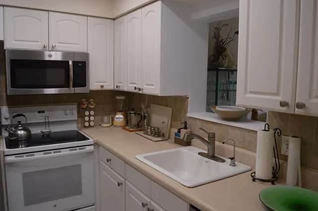 a kitchen with appliances a sink and cabinets