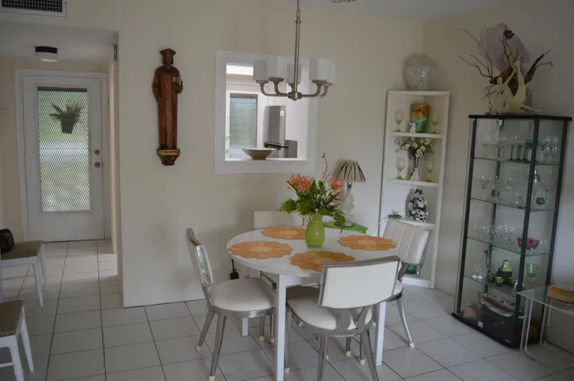 a view of a dining room with furniture and a chandelier