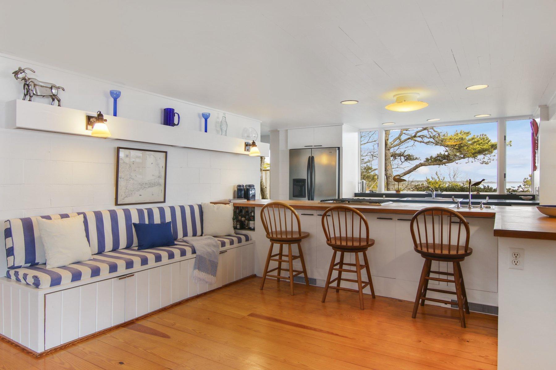 925 Chequessett Neck Road Wellfleet, MA 02667 - Photo 15 of 47 a living room with furniture a rug and white walls