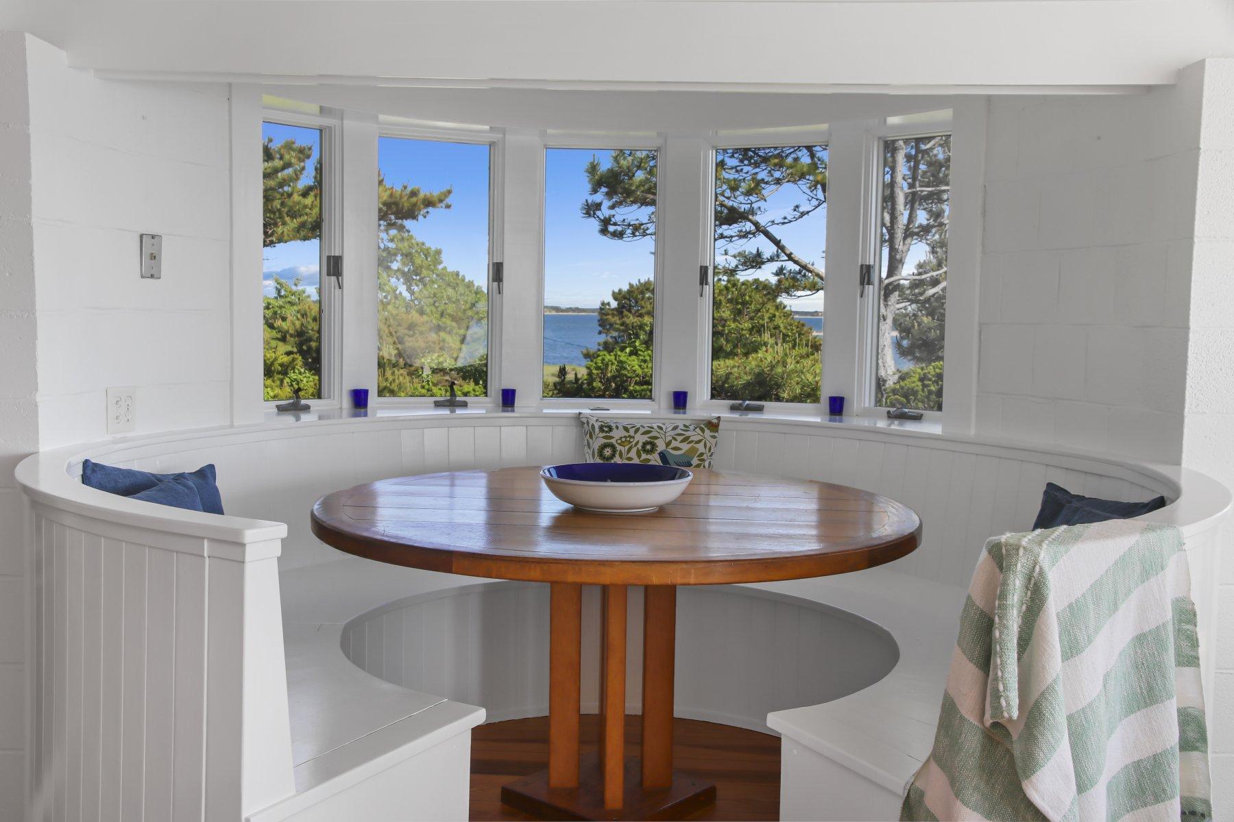 925 Chequessett Neck Road Wellfleet, MA 02667 - Photo 18 of 47 a view of a dining room with furniture window and outside view