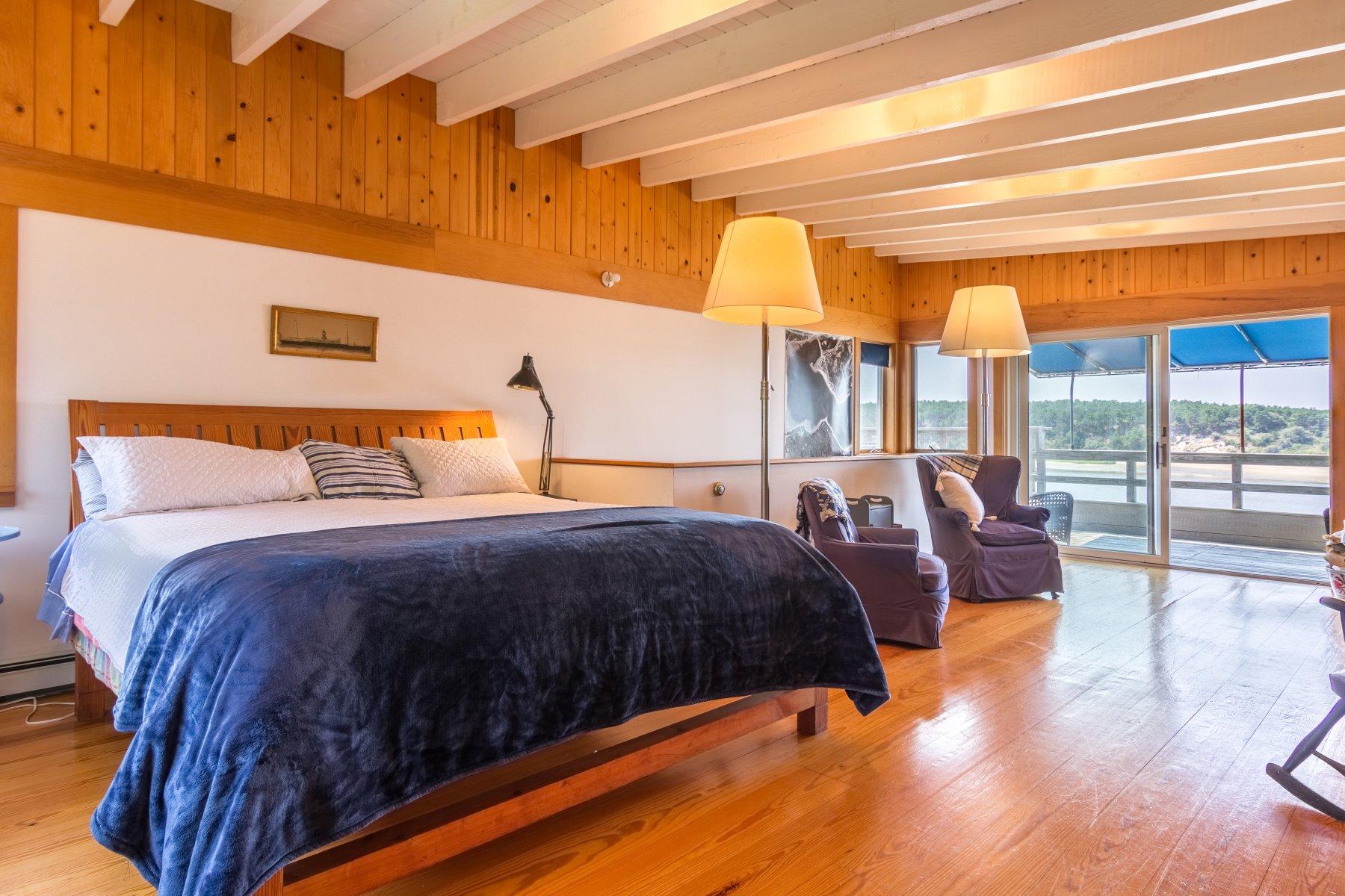 925 Chequessett Neck Road Wellfleet, MA 02667 - Photo 23 of 47 a bedroom with a large bed and a night stand