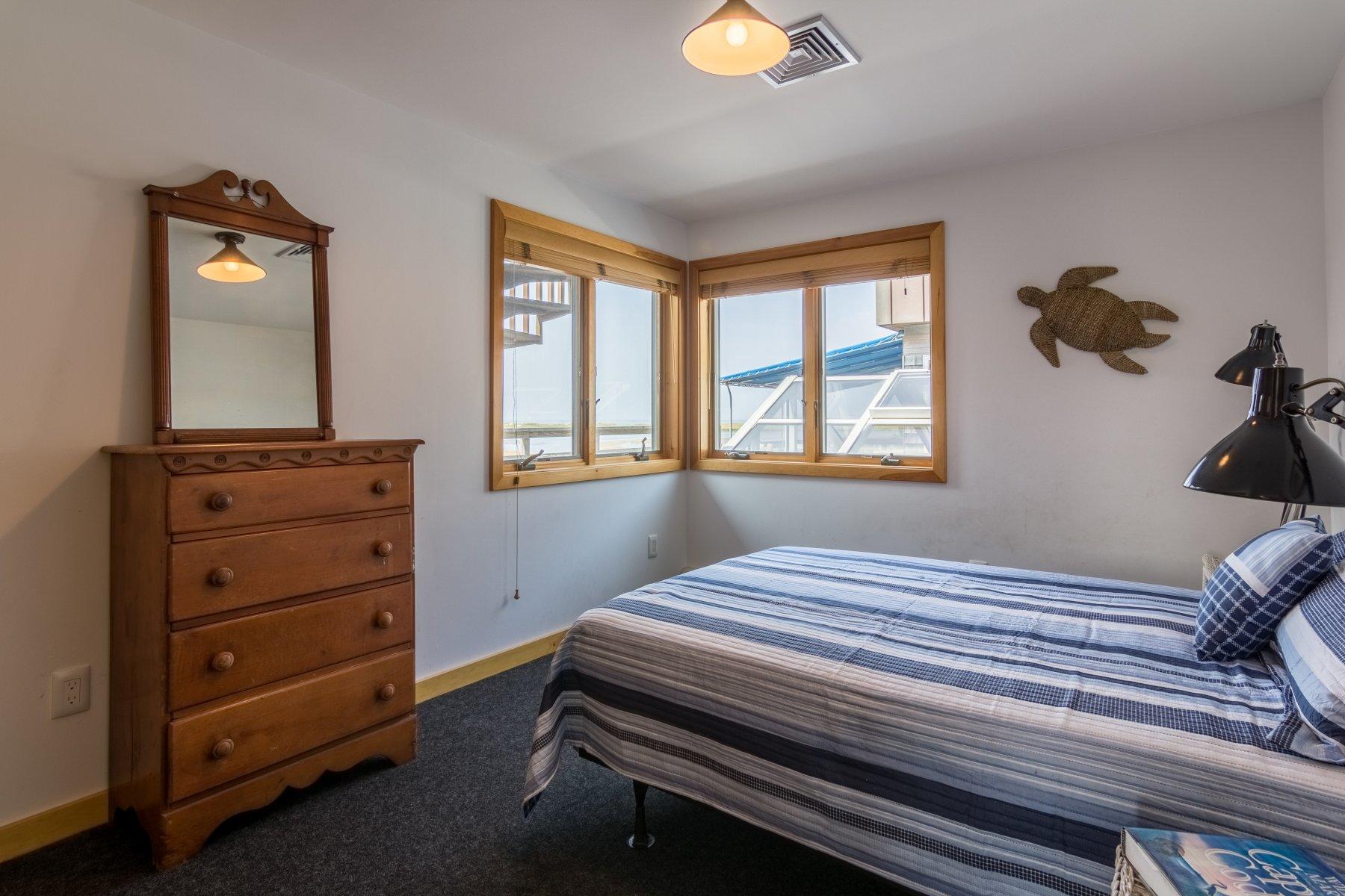 925 Chequessett Neck Road Wellfleet, MA 02667 - Photo 26 of 47 a bedroom with a bed and a dresser