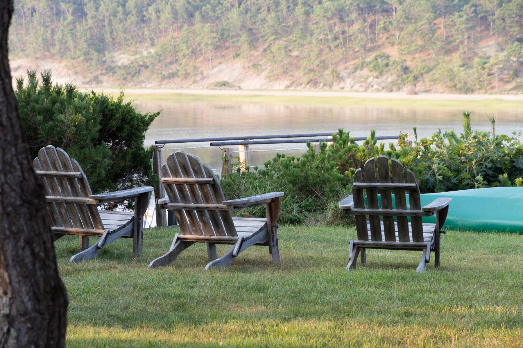 925 Chequessett Neck Road Wellfleet, MA 02667 - Photo 27 of 47 a view of a bench in the garden near a lake