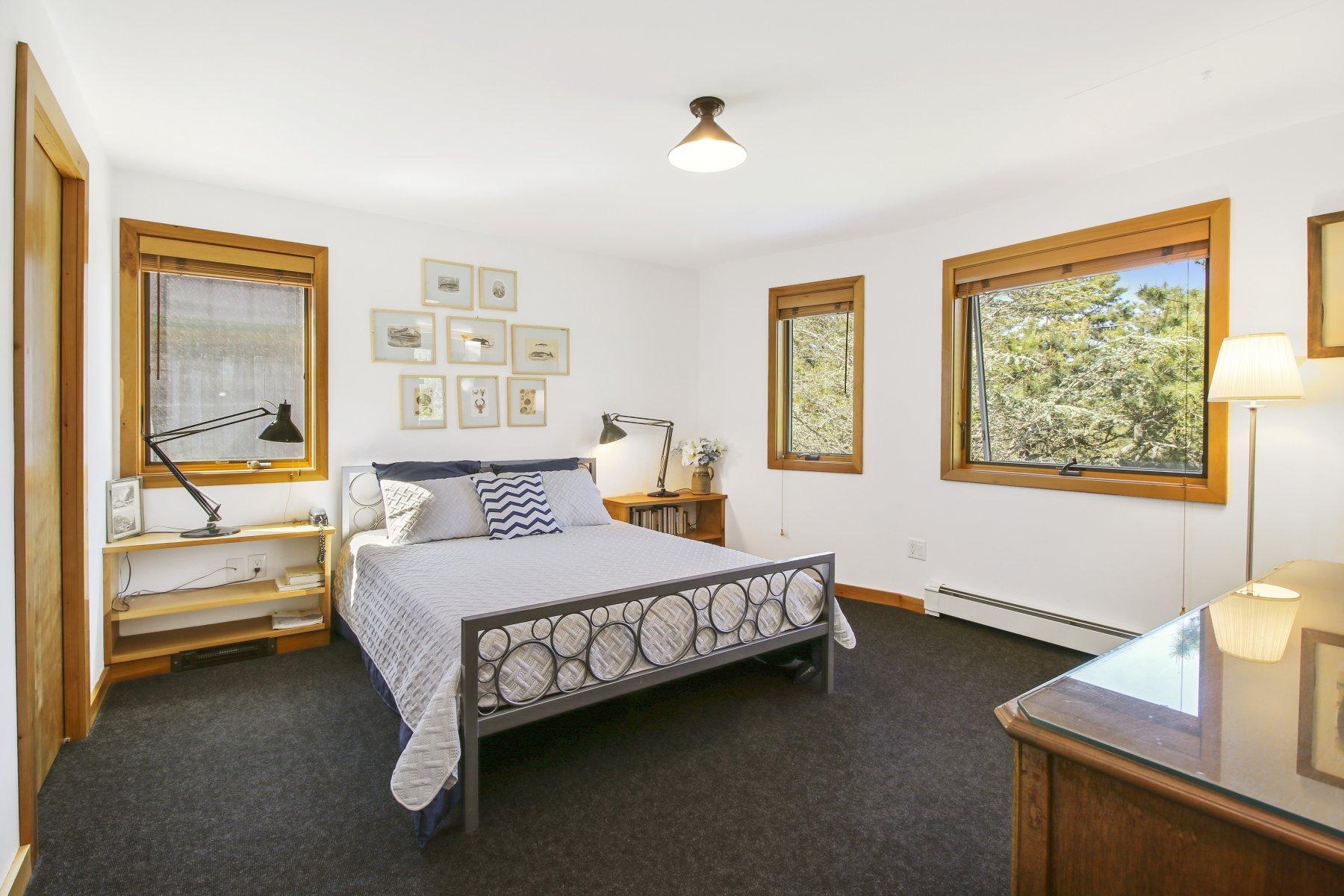 925 Chequessett Neck Road Wellfleet, MA 02667 - Photo 37 of 47 a bedroom with a bed and wooden floor