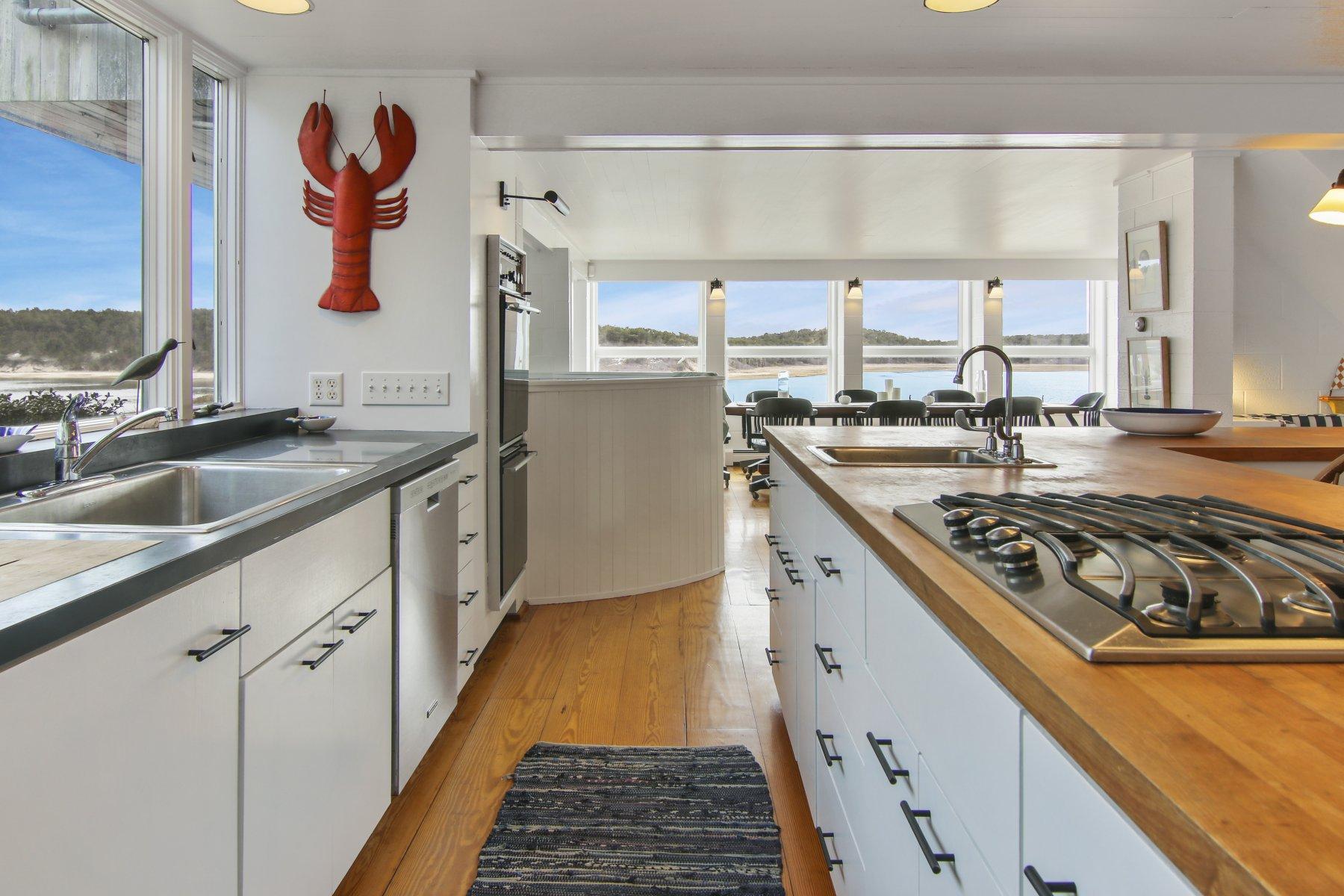 925 Chequessett Neck Road Wellfleet, MA 02667 - Photo 10 of 47 a kitchen with stainless steel appliances granite countertop a stove and a sink