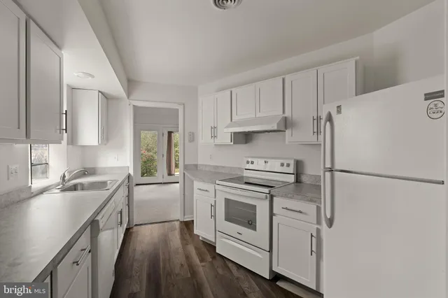 a kitchen with a refrigerator stove and sink
