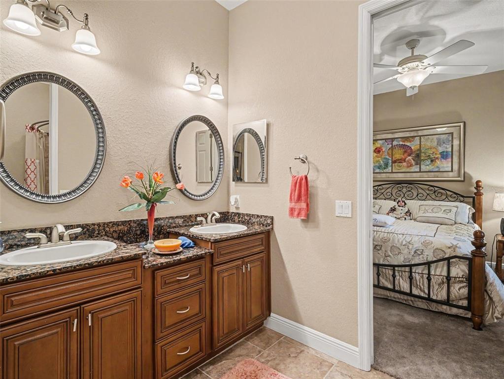 339 Corbett Road Lithia, FL 33547 - Photo 25 of 38 a bathroom with a granite countertop double vanity and a mirror