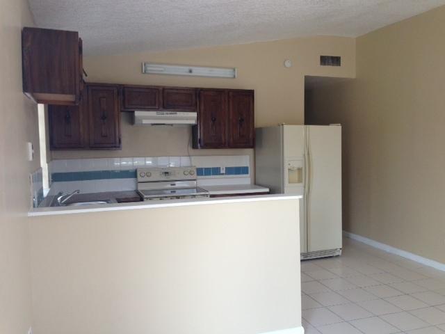 1050 West 7th Street, Unit 1050 Riviera Beach, FL 33404 - Photo 2 of 2 a kitchen with a stove and a refrigerator