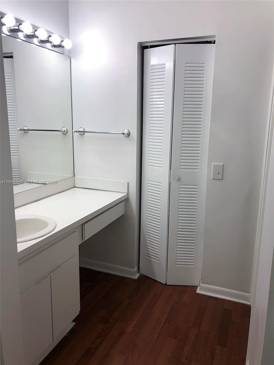 6407 Southwest 132nd Ct Circle Miami, FL 33183 - Photo 12 of 15 an empty room with wooden floor and cabinet