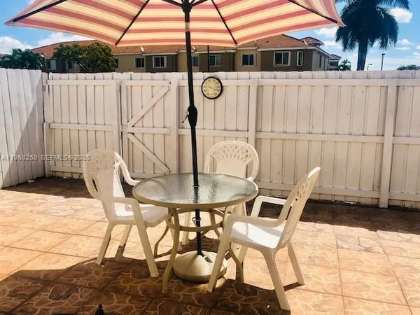 a view of a chairs and table in the patio