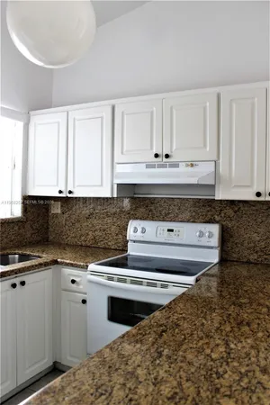 a stove top oven sitting inside of a kitchen
