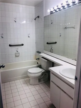 a bathroom with a toilet a sink and bathtub