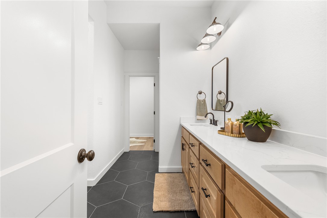 5034 Toscana Loop Bryan, TX 77802 - Photo 20 of 41 a spacious bathroom with a double vanity sink and a mirror