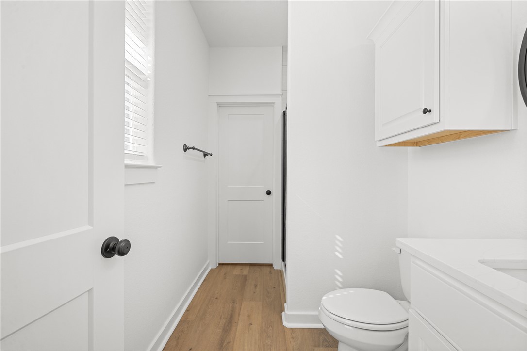 5034 Toscana Loop Bryan, TX 77802 - Photo 25 of 41 a white toilet sitting next to a bathroom sink and vanity