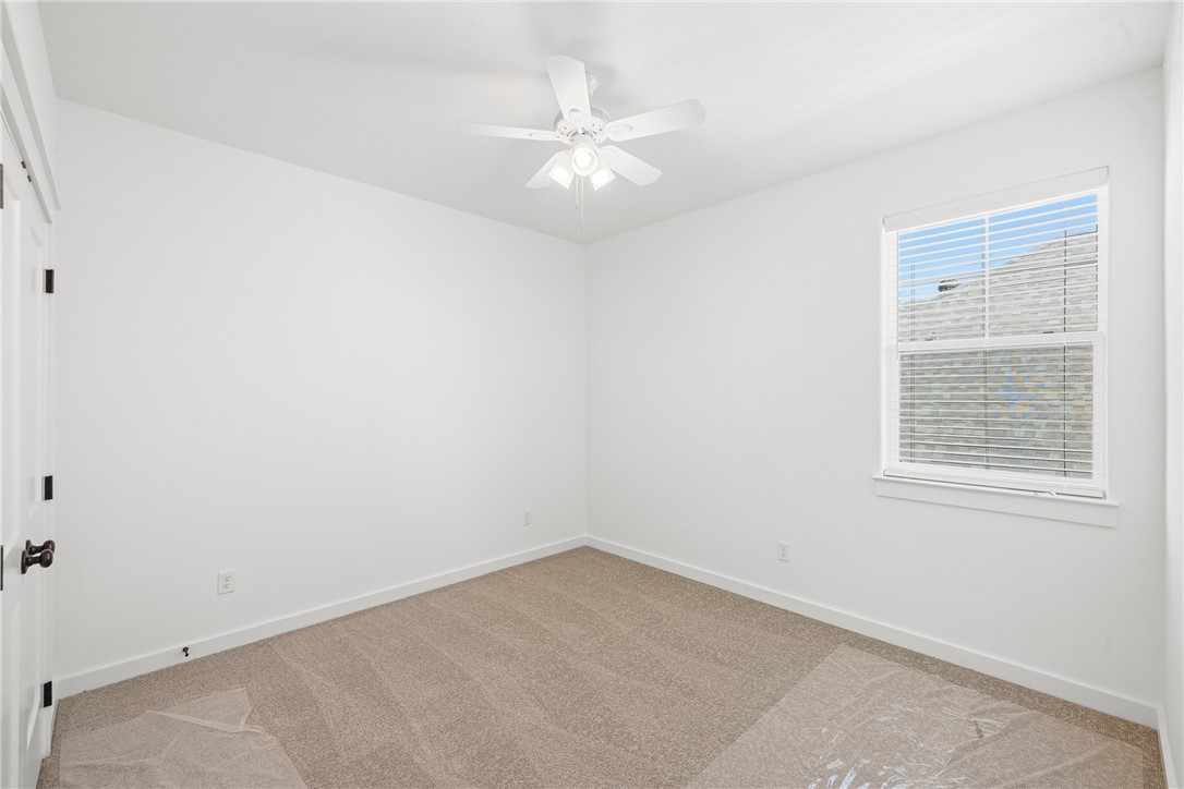 5034 Toscana Loop Bryan, TX 77802 - Photo 27 of 42 an empty room with a window and a fan