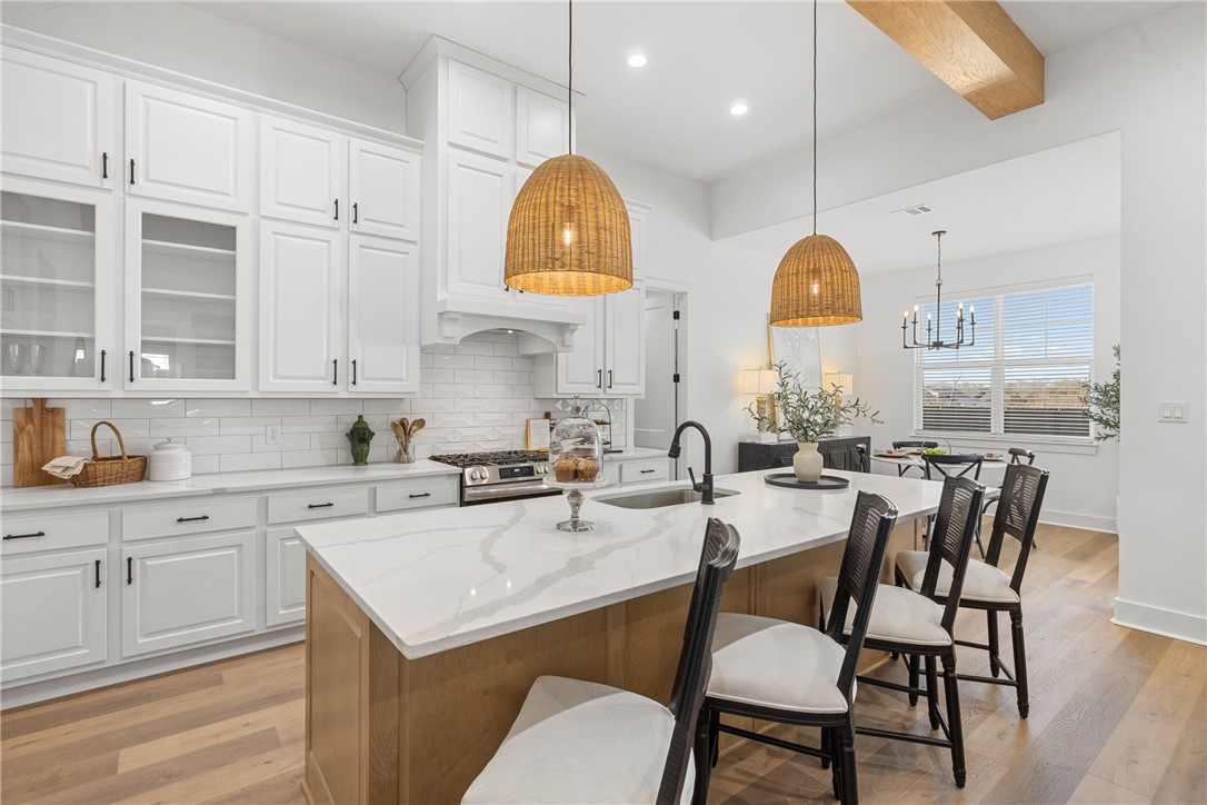 5034 Toscana Loop Bryan, TX 77802 - Photo 9 of 42 a kitchen with a table chairs stove and cabinets