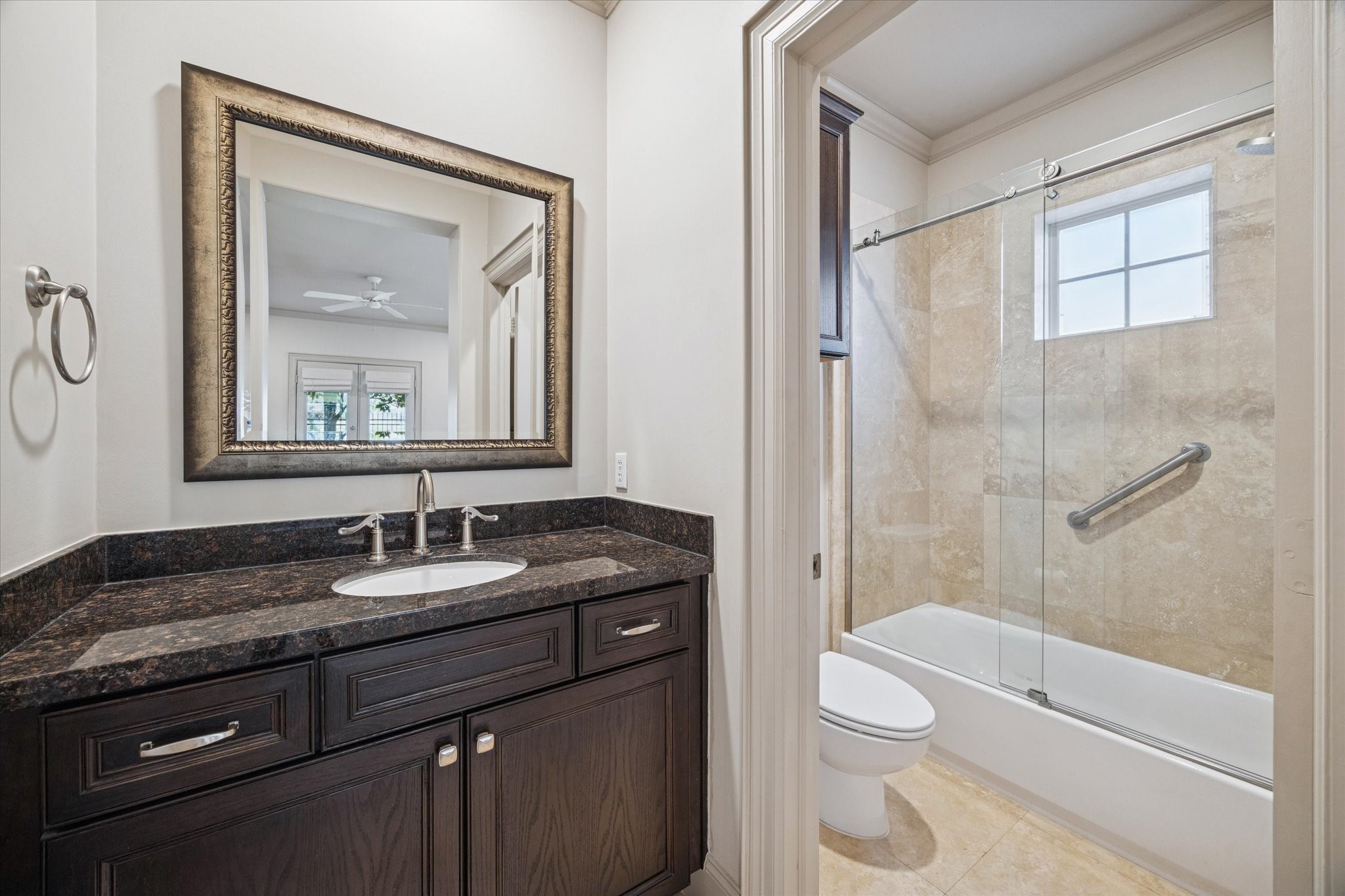1545 Haddon Street Houston, TX 77006 - Photo 17 of 30 a bathroom with a granite countertop toilet a sink and a mirror