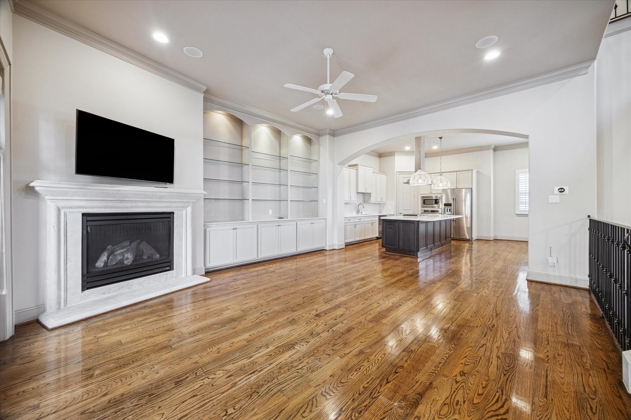 1545 Haddon Street Houston, TX 77006 - Photo 20 of 30 a view of a livingroom with a fireplace a flat screen tv and staircase